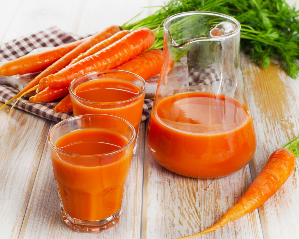 Fresh Carrot Juice And Organic Raw Carrots On A Wooden Table.