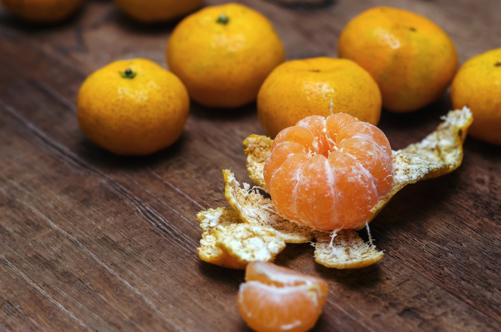 Ripe mandarines on wooden background